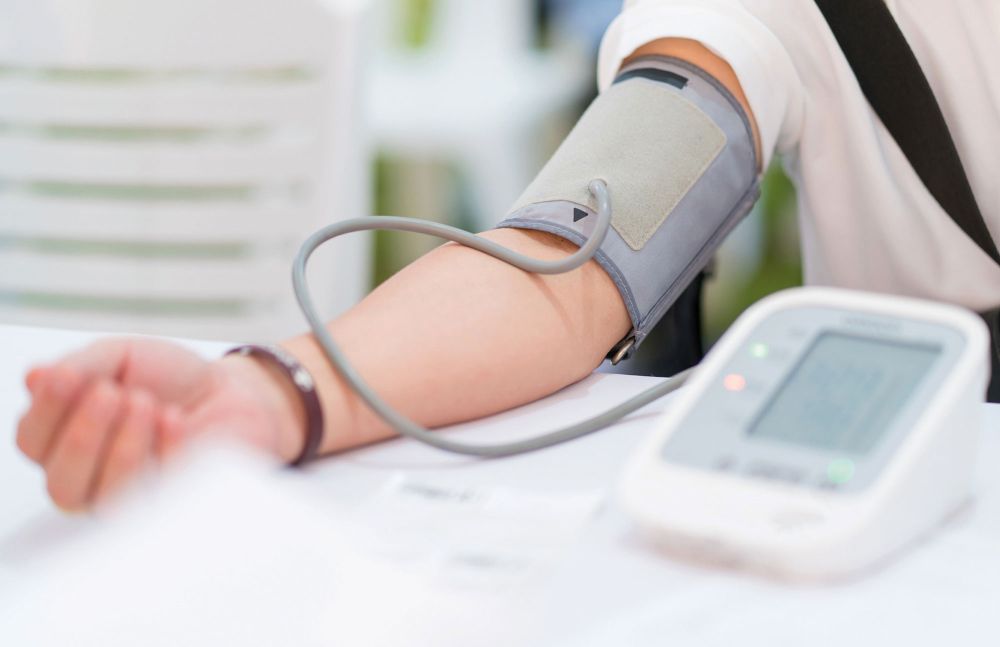 Nahaufnahme eines Arms mit angelegter Blutdruckmanschette